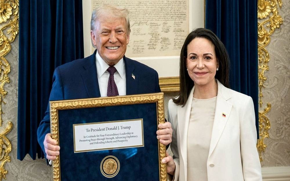 Venezuela opposition leader Machado presents her Nobel Peace Prize medal to Trump